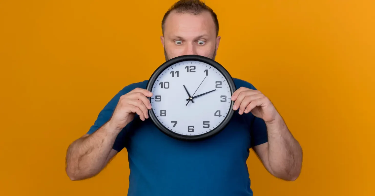 Person holding a clock representing how many seconds in a year